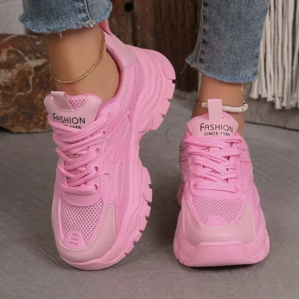 Pink chunky platform lace-up sneakers with lace-up closure and cushioned sole