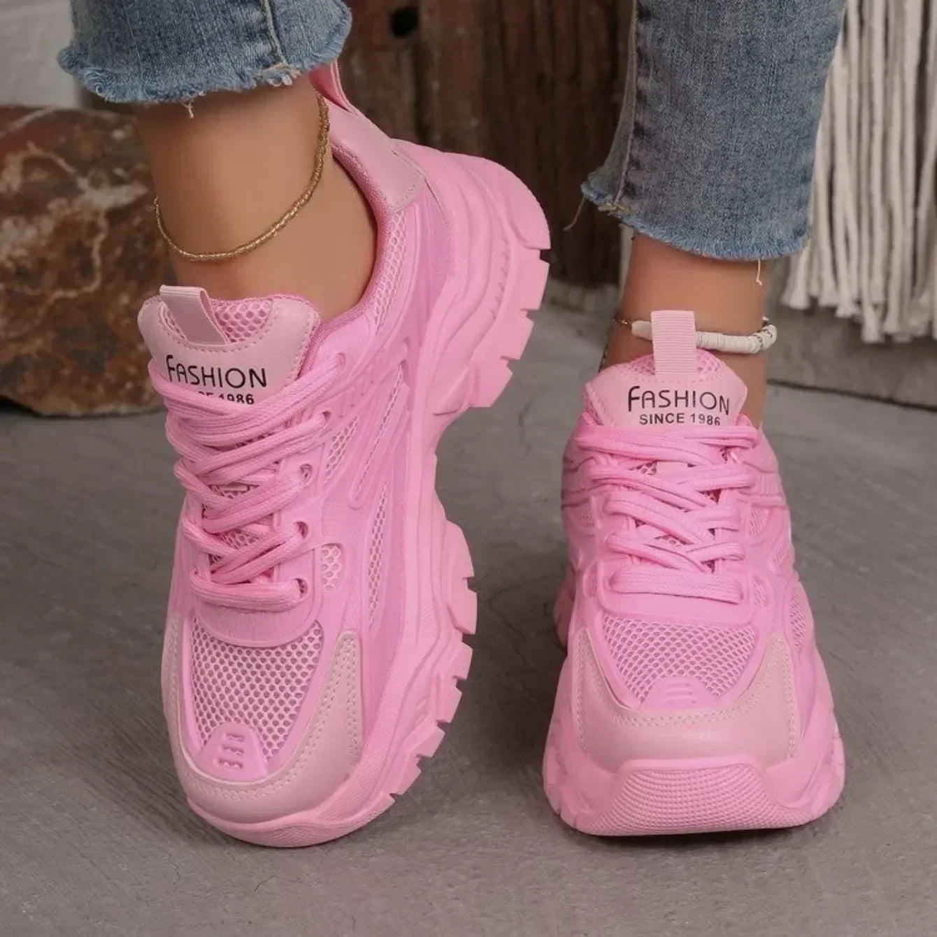Pink chunky platform lace-up sneakers with lace-up closure and cushioned sole