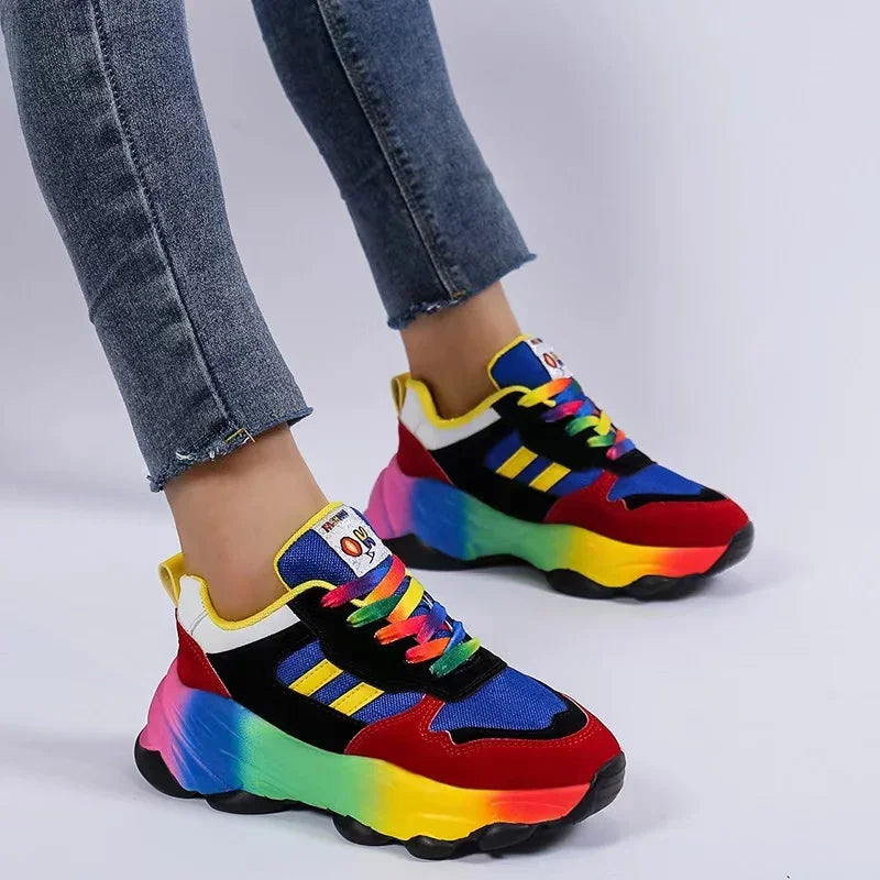 Blue-and-red platform sneakers with neon yellow sole and colorful laces on feet