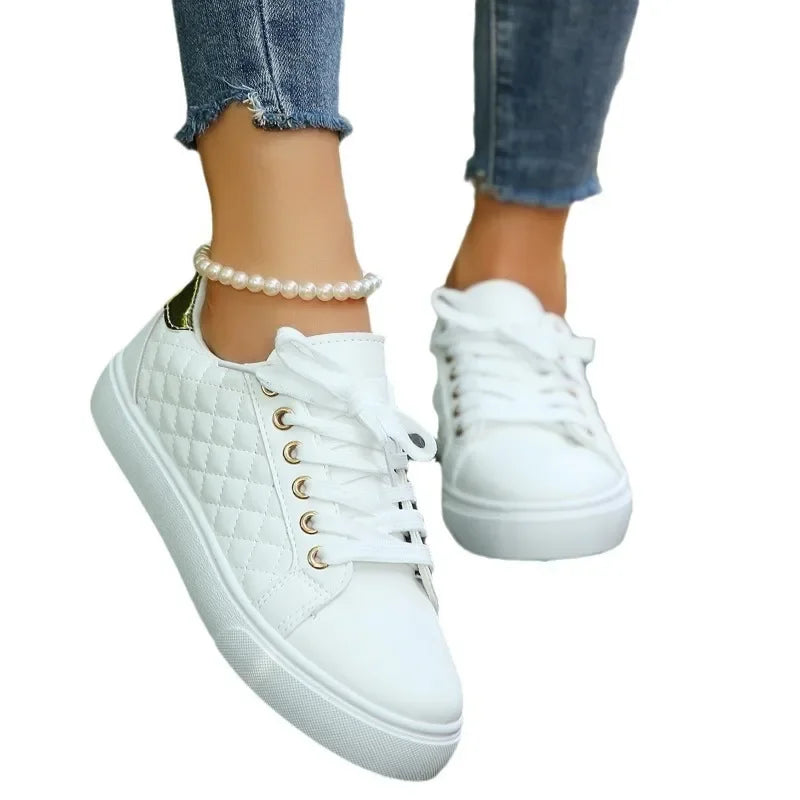 White quilted lace-up platform sneakers with gold eyelets and thick white rubber sole