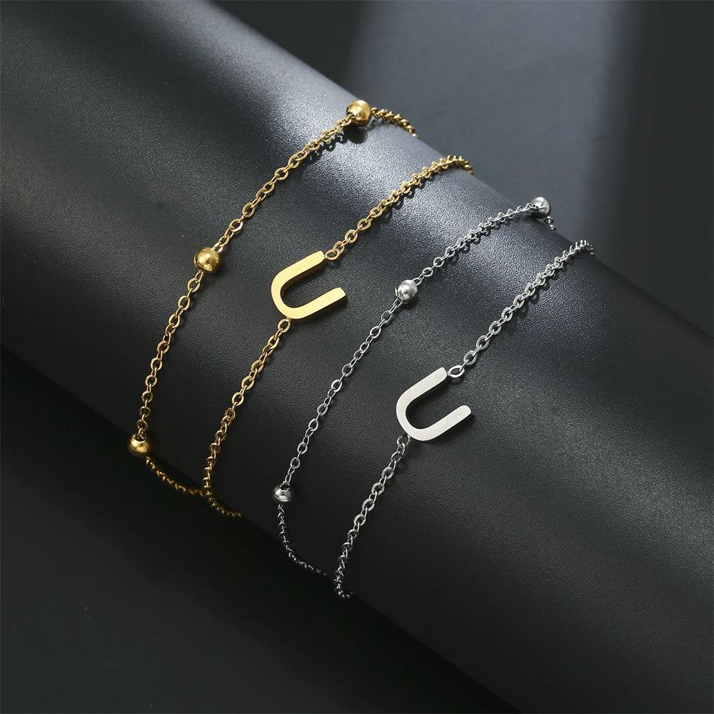 Initial letter bracelet set with U and U charms; gold and silver-tone chains