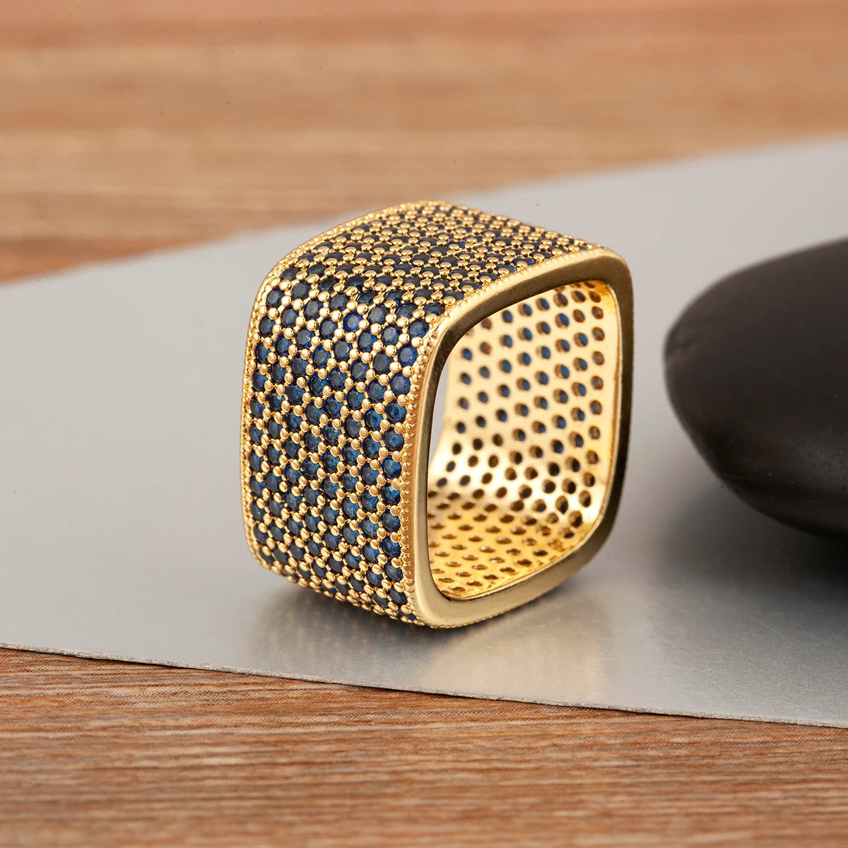 Square open adjustable rhinestone ring with deep blue stones and gold-tone interior