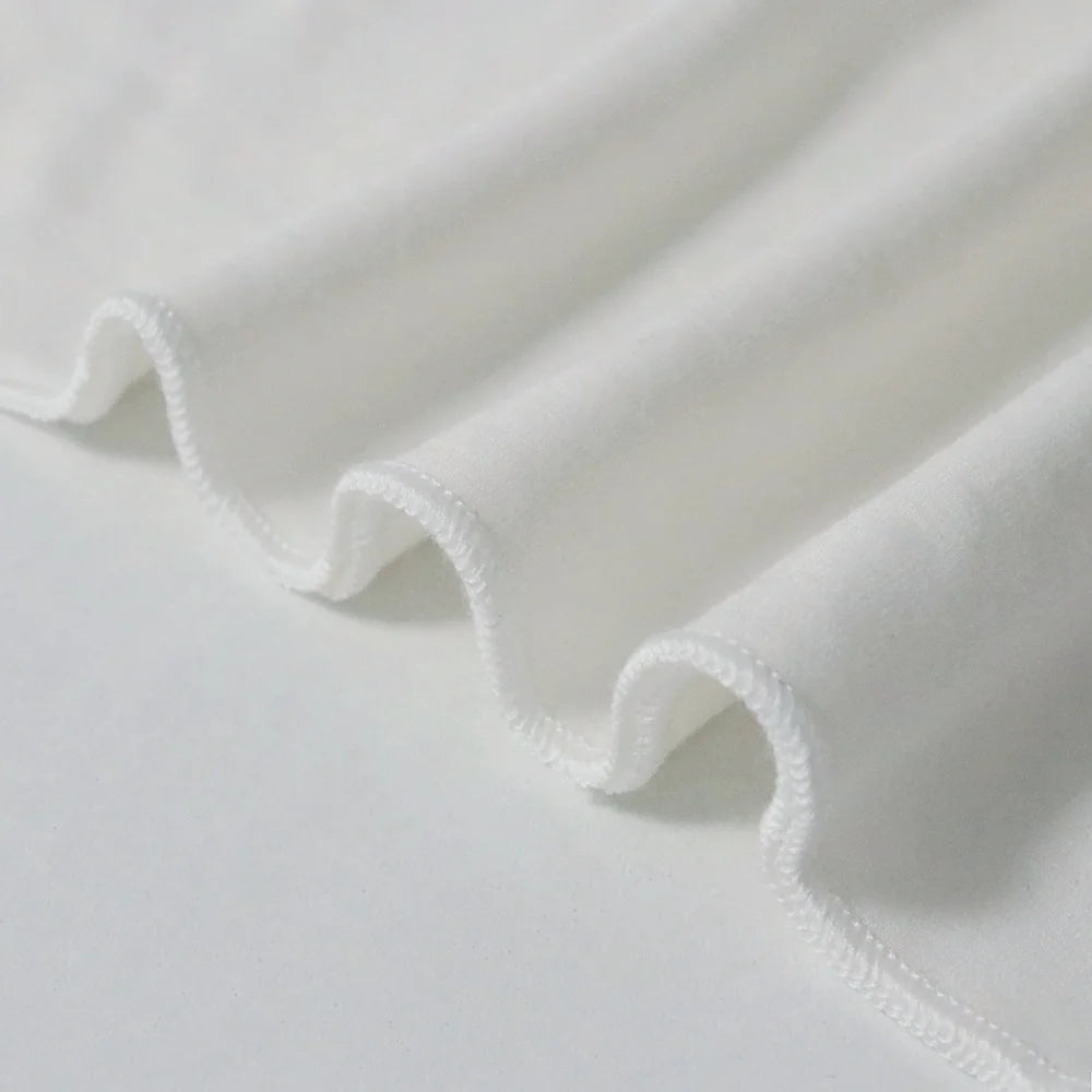 White women’s racerback tank top, close-up of hem edge and stitching