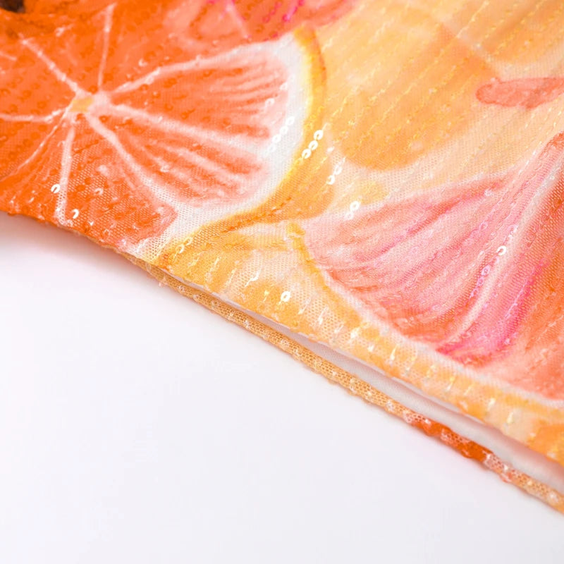 Citrus print crop top hem and fabric close-up with sparkly texture