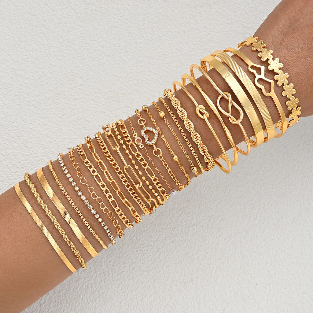 Gold-tone charm bracelet set with heart and flower-style link accents