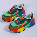 Green and multicolor platform sneakers with orange laces and rainbow gradient sole