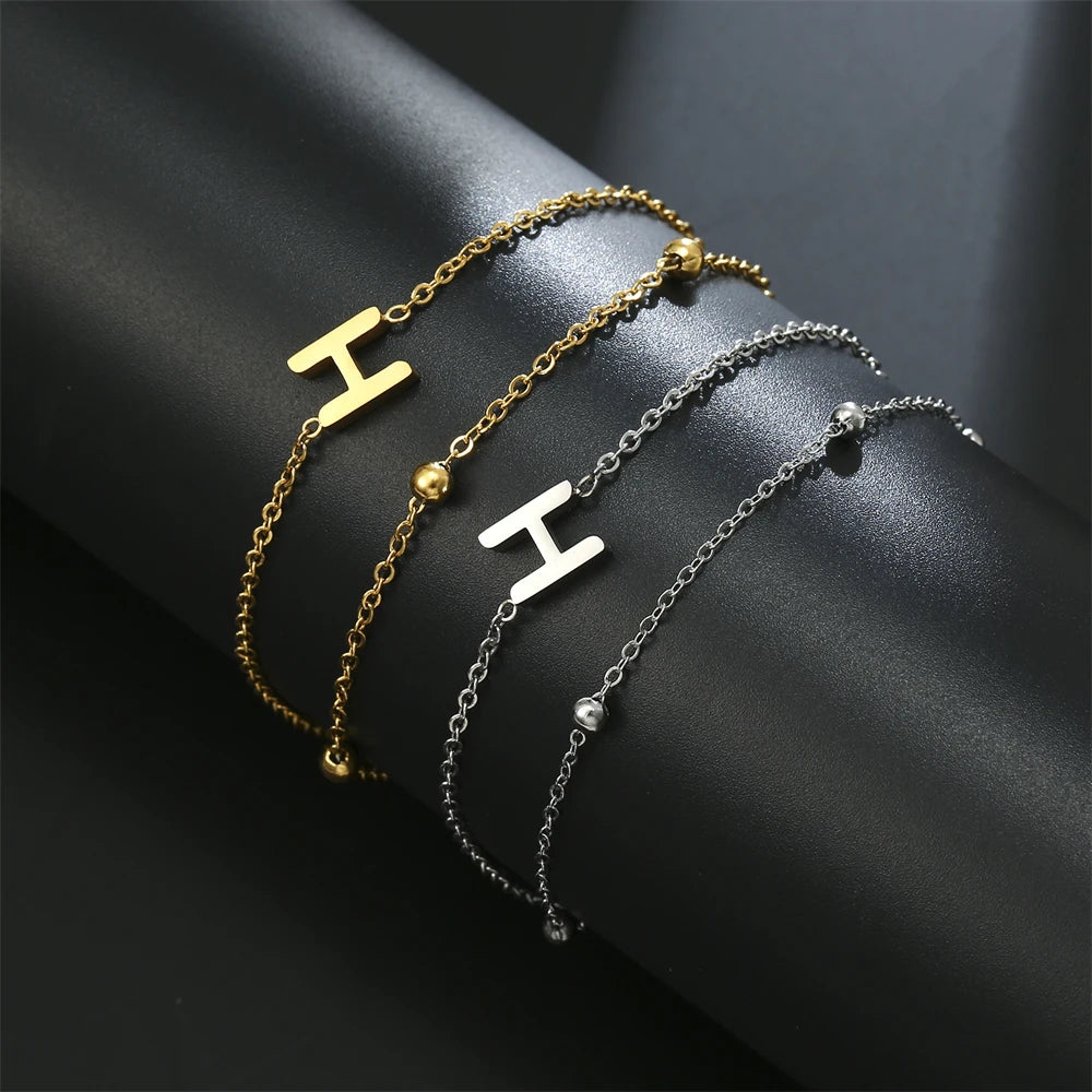 Initial letter bracelet set with H and A charms; gold and silver-tone chains