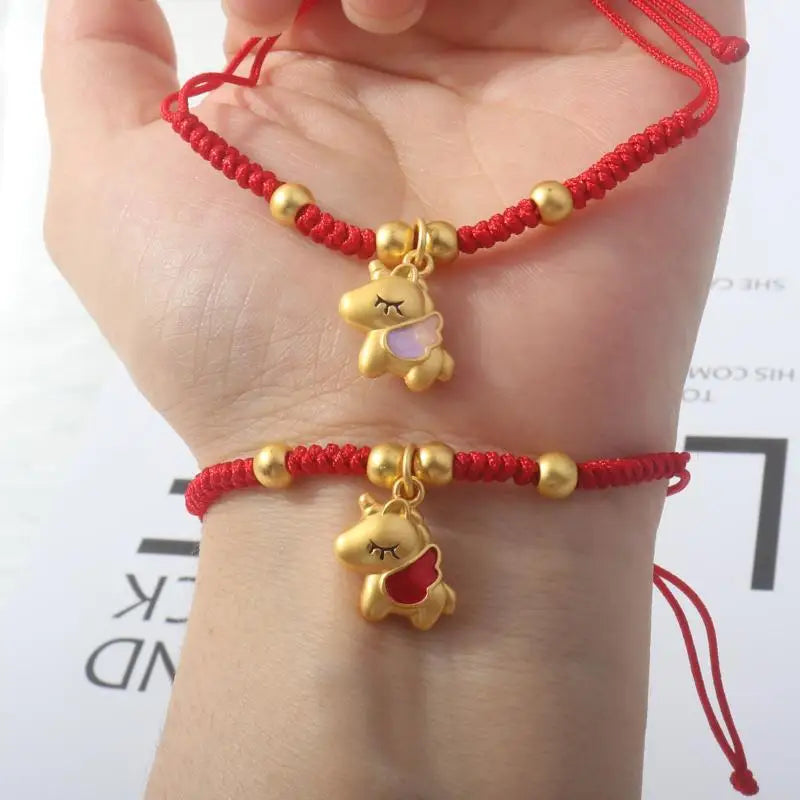 Red rope bracelet stack with gold beads and small horse charm pendants