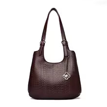 Burgundy leather shoulder bag with short handles and flower logo charm