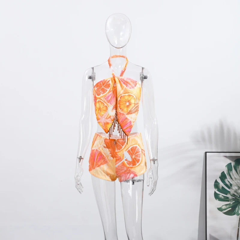 Halter crop top and shorts set on mannequin, citrus print halter bow with tassels