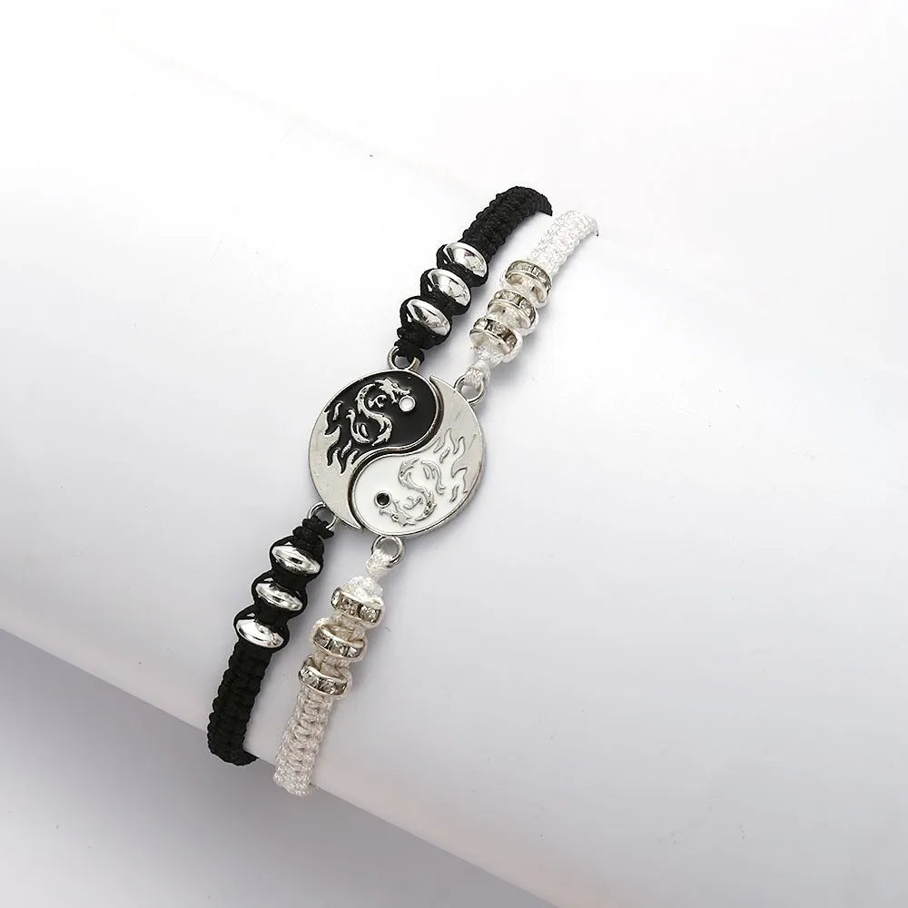 Adjustable bracelet with yin-yang dragon pendant and black-and-silver bead accents