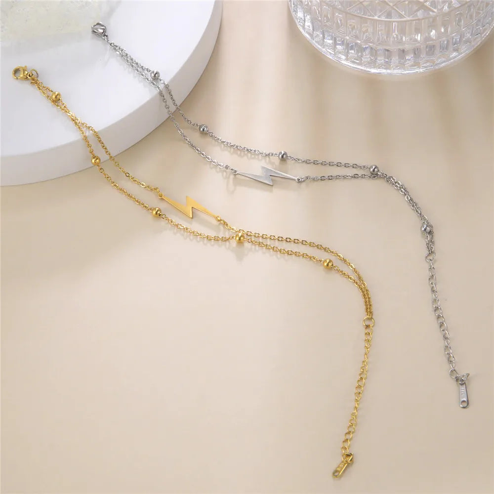 Gold-tone and silver-tone chain lightning charm bracelets with bolt pendants