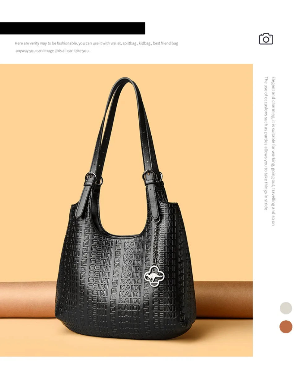 Black leather shoulder bag with dual handles and embossed logo pattern with clover charm