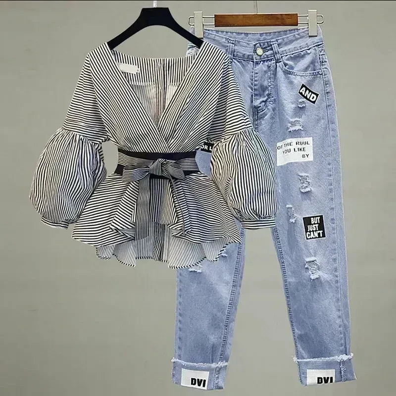 Striped top paired with light-wash ripped jeans on hangers