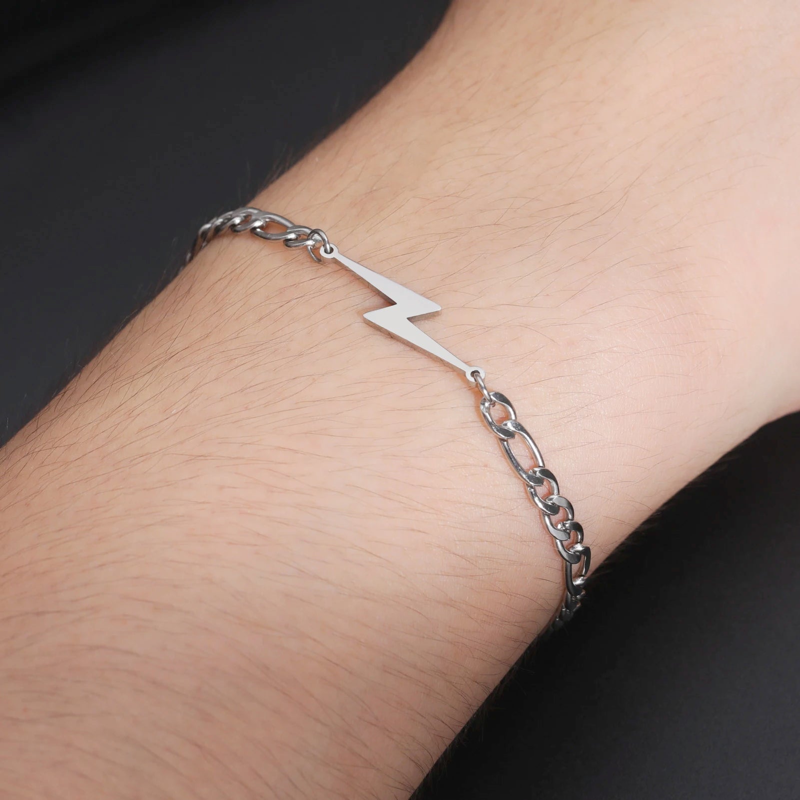Silver-tone chain lightning bolt charm bracelet on wrist