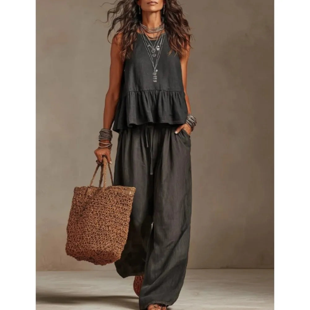Black sleeveless ruffled top and wide-leg trouser set with tiered peplum