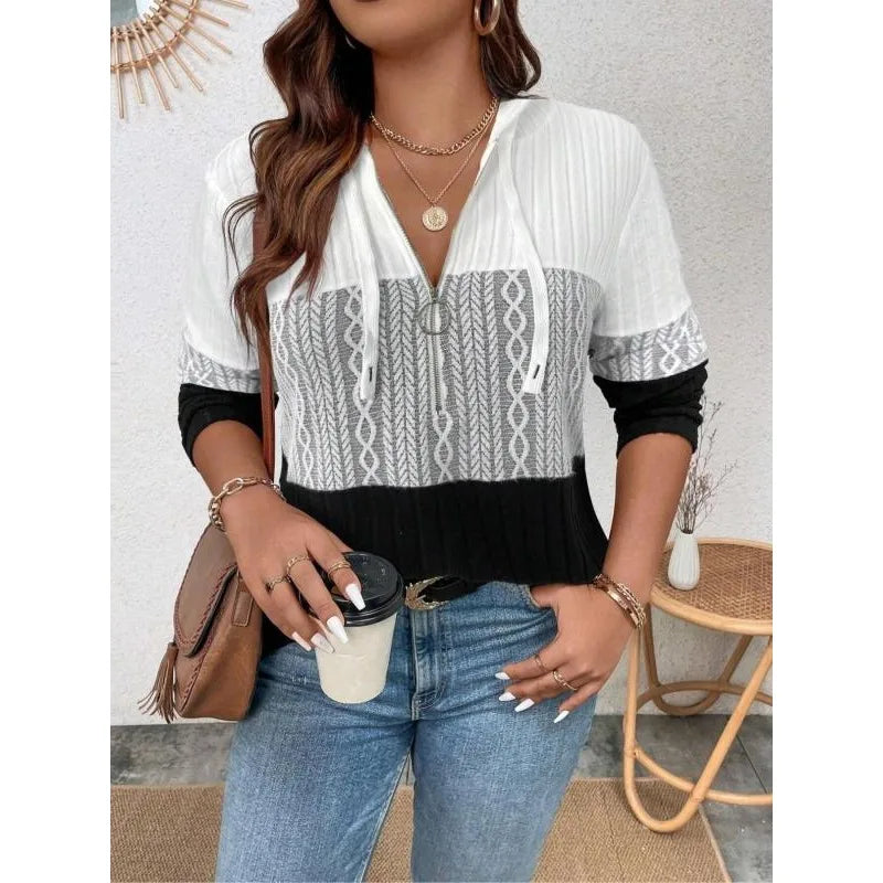 Hooded zip-up top with patterned center and drawstring hood, long sleeves in white and black