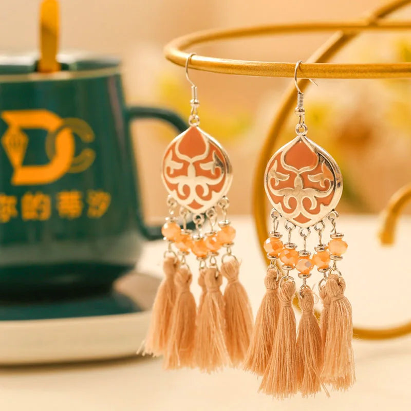 Boho tassel drop earrings with orange teardrop motif, peach tassels and bead clusters