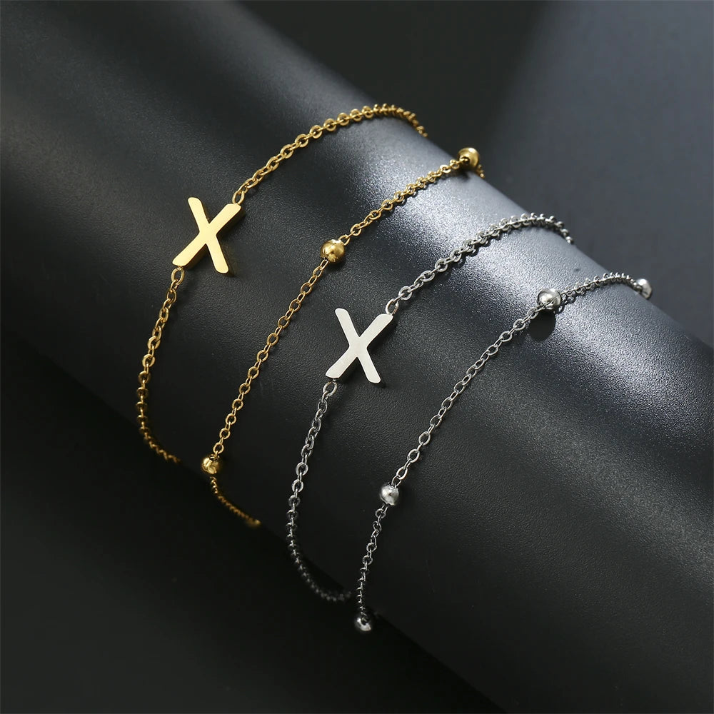 Initial letter bracelet set with X and X charms; gold and silver-tone chains