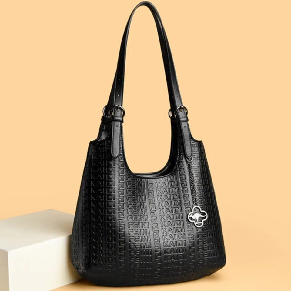 Black leather shoulder bag with dual handles and embossed logo texture