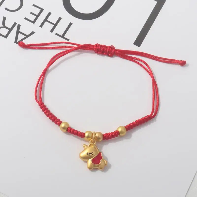 Red rope charm bracelet with gold beads and gold horse silhouette charm.