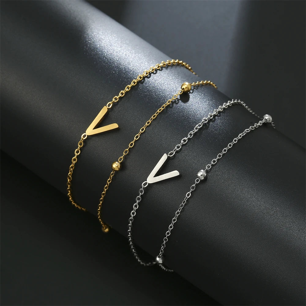 Initial letter bracelet set with L and L charms; gold and silver-tone chains