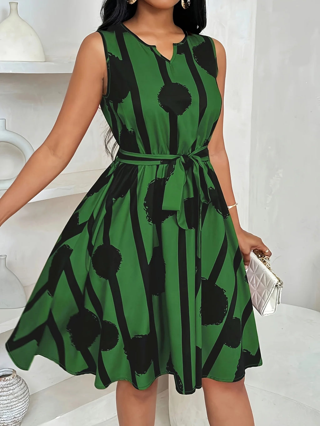 Plus-size sleeveless printed dress with tie waist and V-neck, green with black pattern