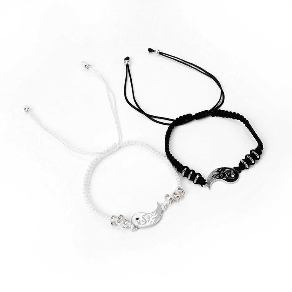 Set of two adjustable cord bracelets with yin-yang dragon moon pendants, black and white