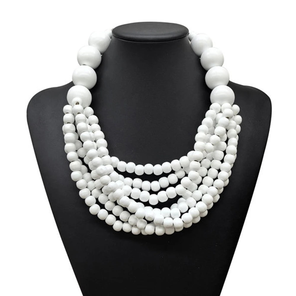 Multi-layer wooden beaded necklace with white round beads on a black display bust