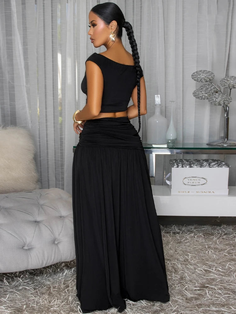 Black off-shoulder cropped top and high-slit maxi skirt set with flower brooch detail