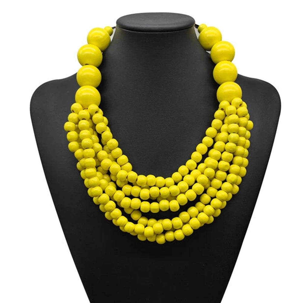 Multi-layer wooden beaded necklace with yellow round beads on a black display bust