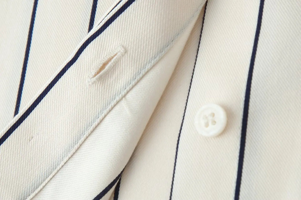 Striped shirt sleeve and pocket detail with button, off-white with navy pinstripes
