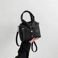 Square PU leather crossbody bag in black with front flap pocket and snap button details