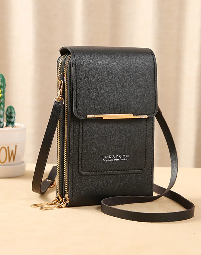 Black PU phone crossbody wallet with top flap, gold zipper, and adjustable strap.