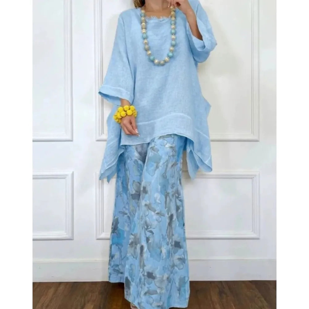 Sky blue printed tunic and wide-leg pants set with flowy drape and gold necklace
