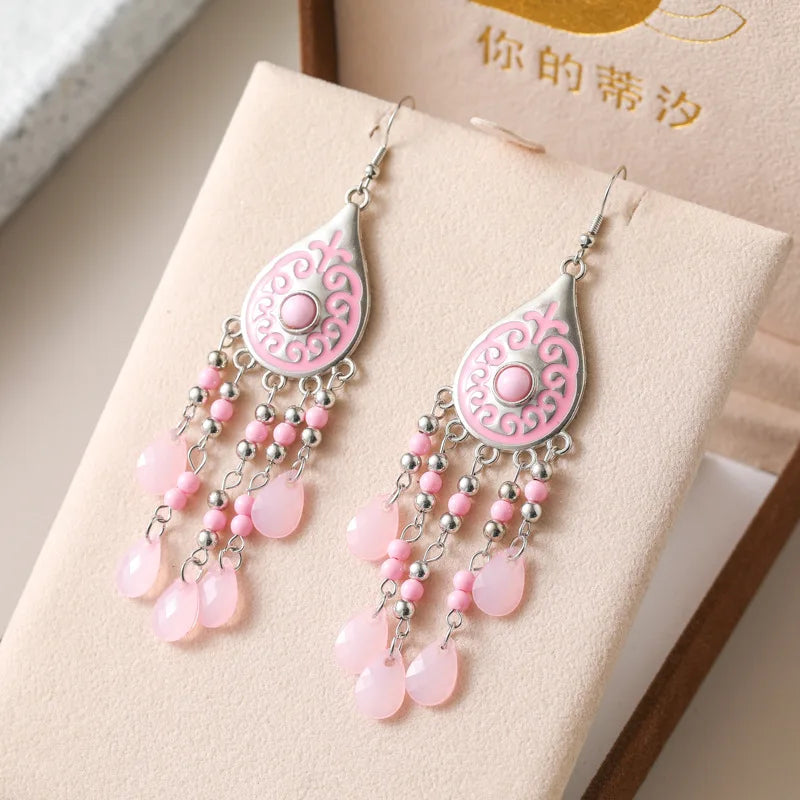 Pink teardrop bead tassel dangle earrings with ornate filigree and silver hooks