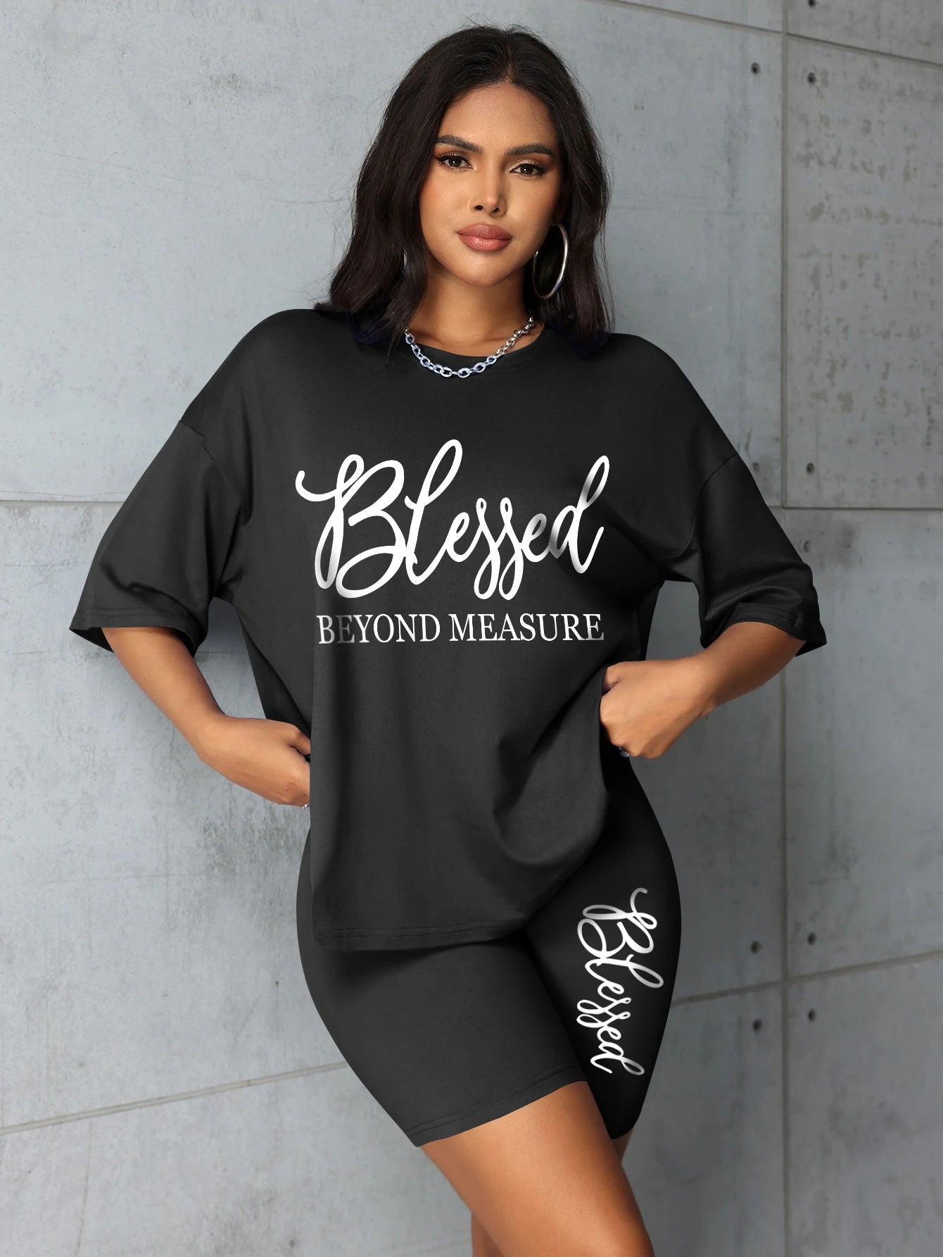 Women's plus size black graphic t-shirt & biker shorts set with 'Blessed'