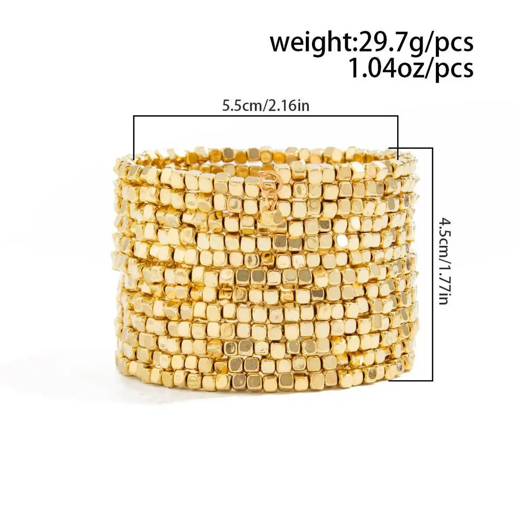 Gold-tone wide beaded cuff bracelet with multiple layers of square beads.