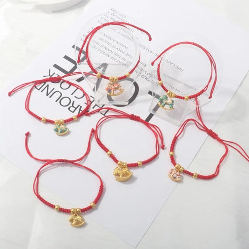 Set of red rope horse charm bracelets with gold beads and dangling pendants