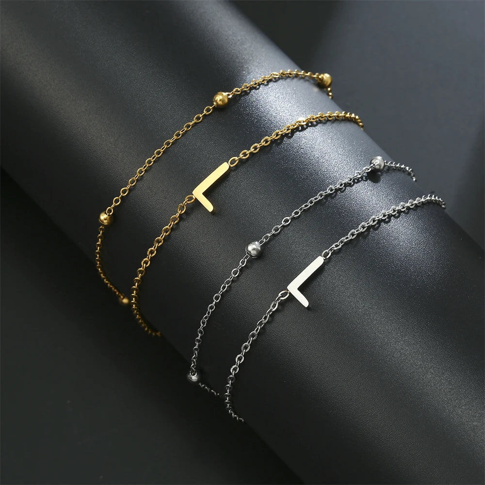 Initial letter bracelet set with K and K charms; gold and silver-tone chains