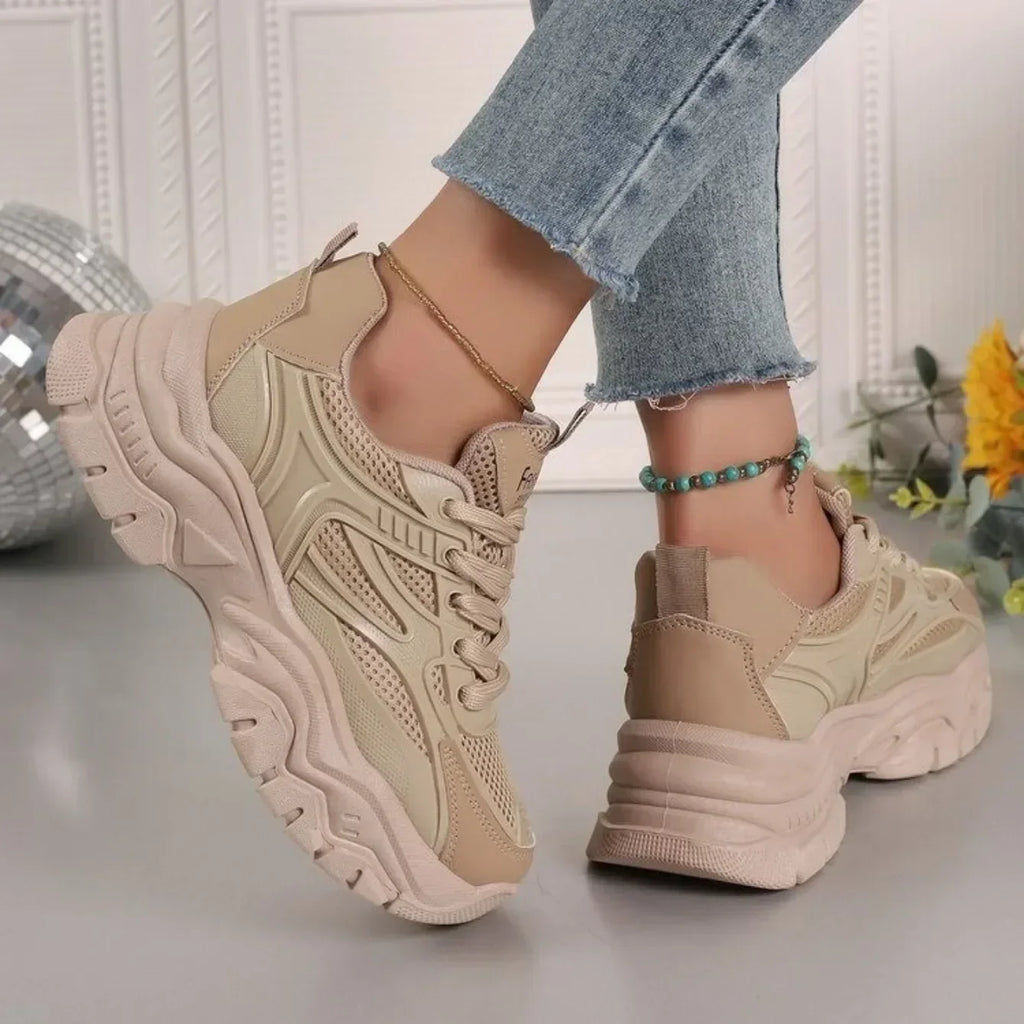 Beige chunky platform lace-up sneakers with textured panels and thick outsole
