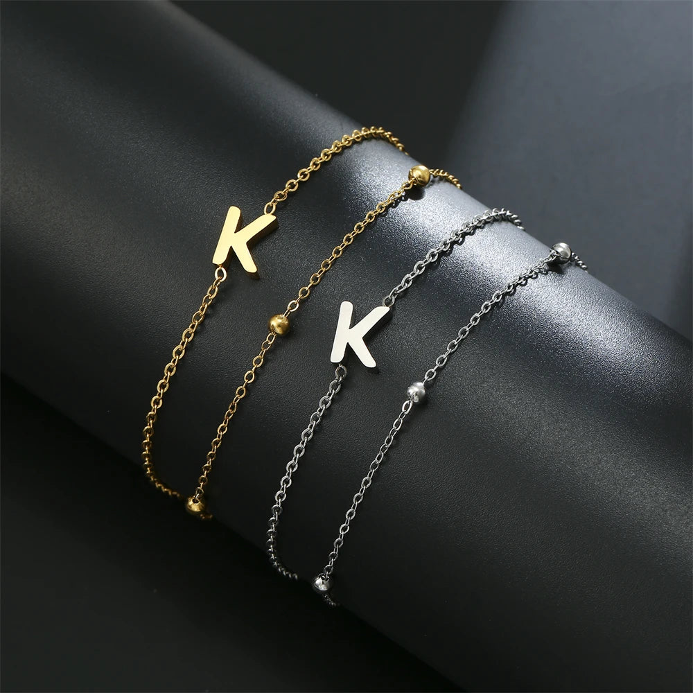 Initial letter bracelet set with K and K charms; gold and silver-tone chains