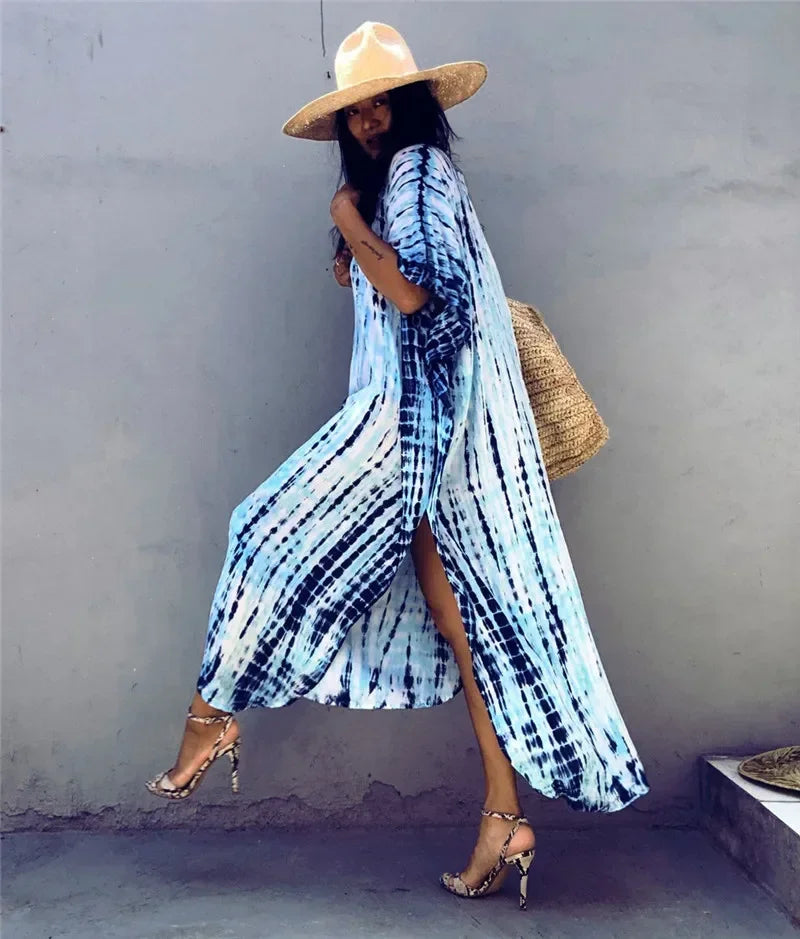 Women’s boho striped beach kaftan in light blue and white; V-neck, flowy maxi dress.