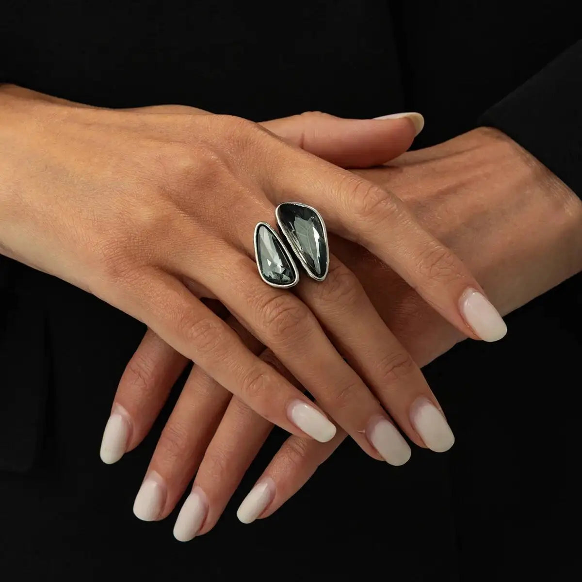 Silver open rings with oval dark faceted rhinestones in geometric settings