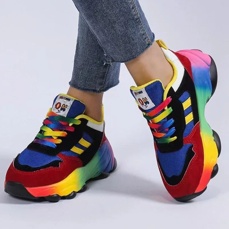Women's platform sneakers with multicolor panels, thick tread sole, and lace-up design.