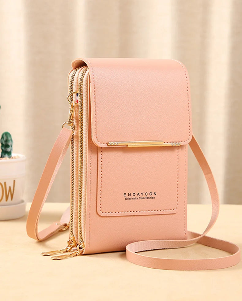 Peach pink PU phone crossbody wallet with top flap, gold zipper, and crossbody strap.