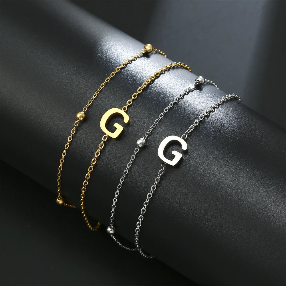 Initial letter bracelet set with G and G charms; gold and silver-tone chains