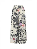 Women’s plus size wide-leg pants, cream with black animal-and-face collage print, colorful pops