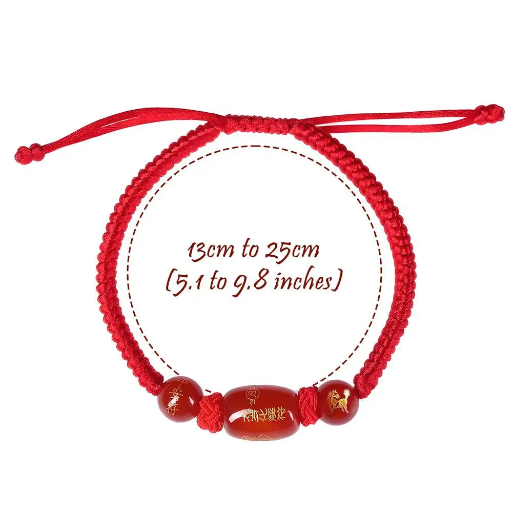 Red adjustable string bracelet, size 13–25 cm, with oval brown bead and charms