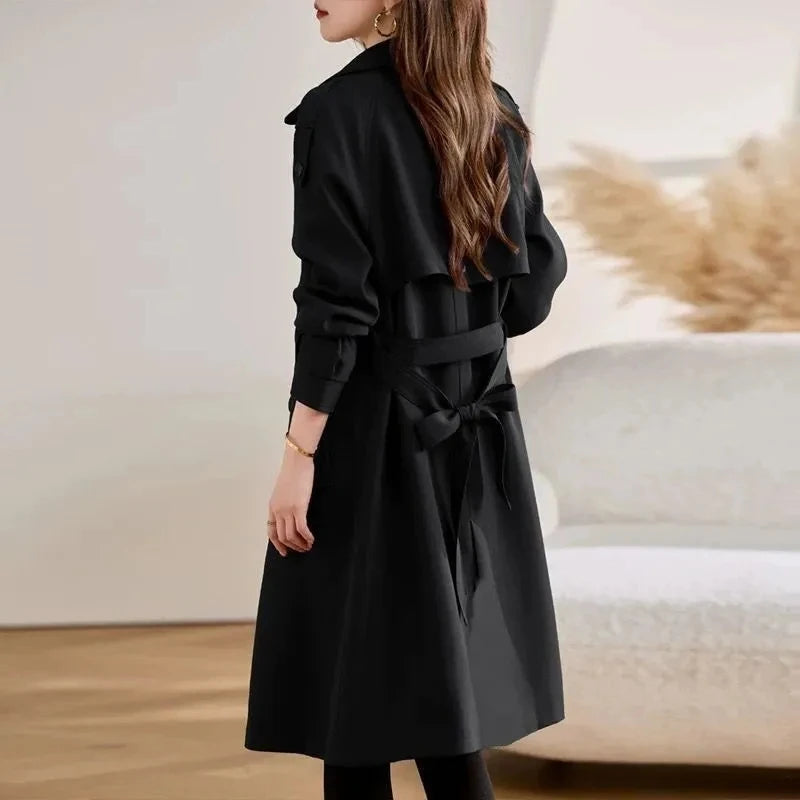Women’s black belted trench coat with notched lapels and double-breasted front